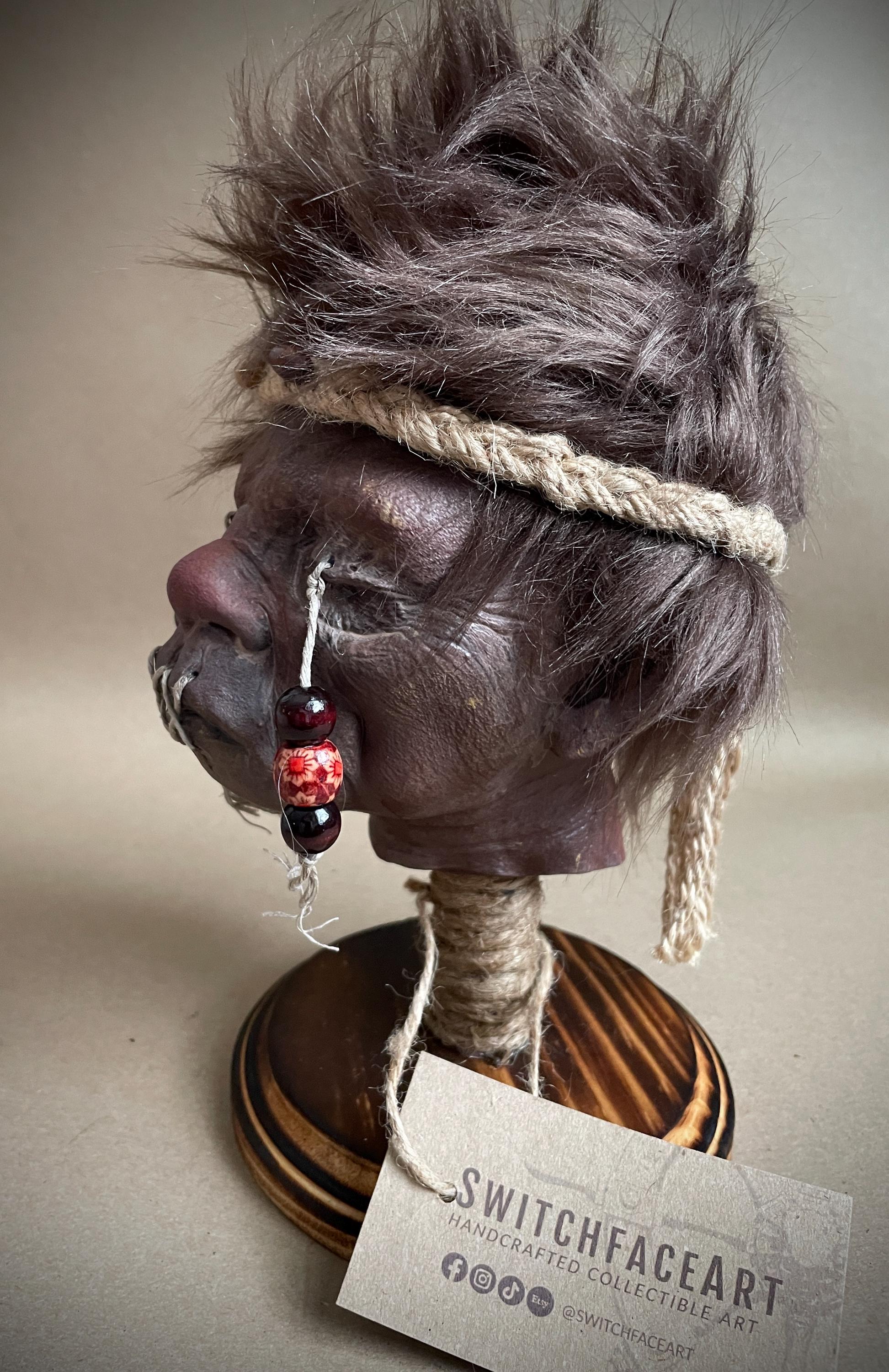 Elder Shrunken Head – Dark Brown Tsantsa Artifact with Stand