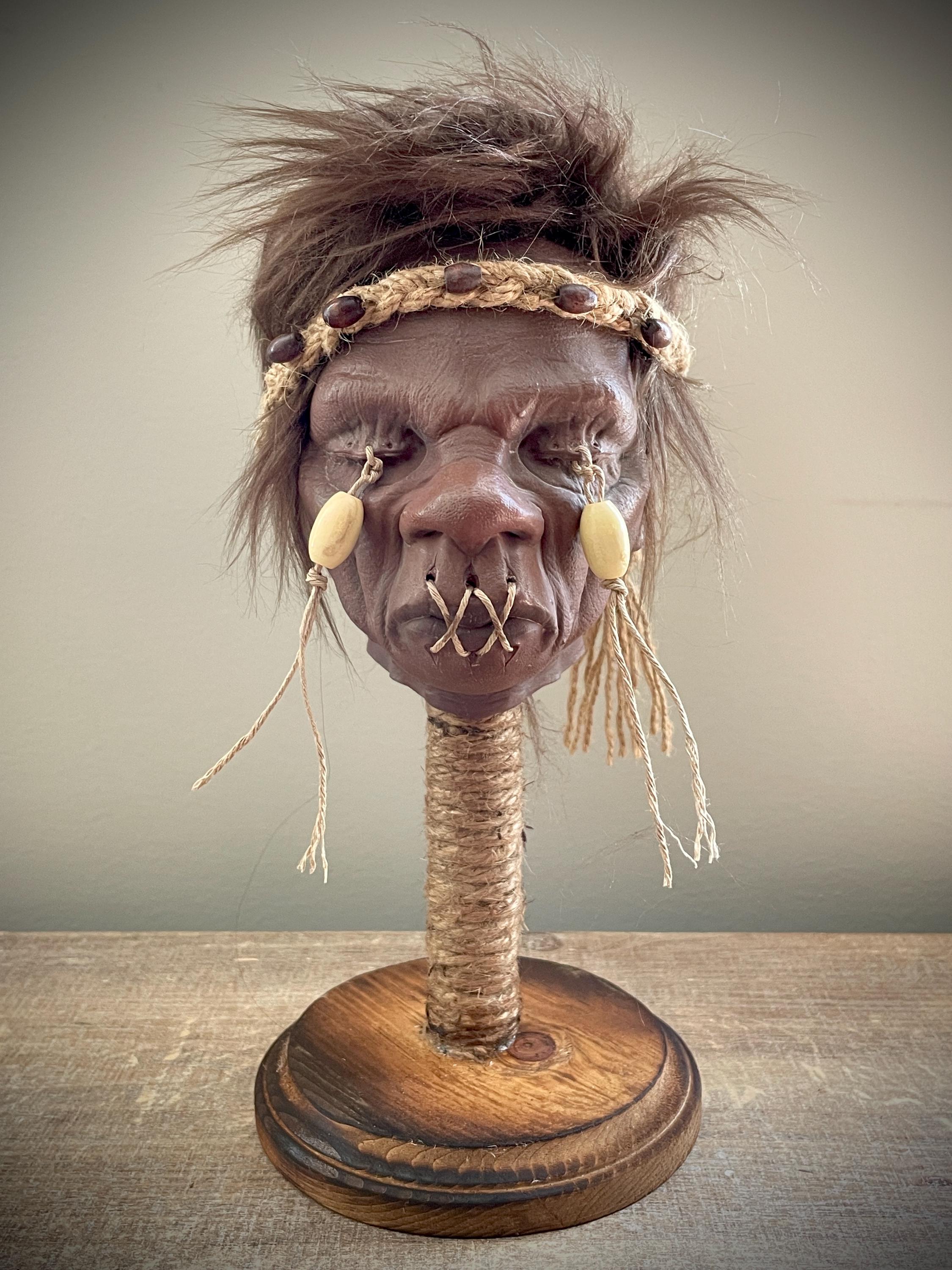 Elder Shrunken Head – Dark Brown Tsantsa Artifact with Stand